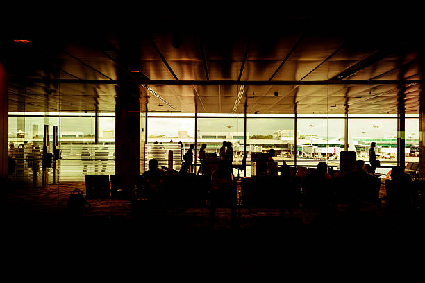 People Waiting for the Flight in Airport Lobby