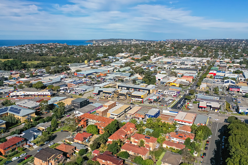 Sydney NSW Australia - June 22nd 2022 - Aerial drone view of Brookvale commercial industrial area, Northern Beaches are with Manly in the distance.