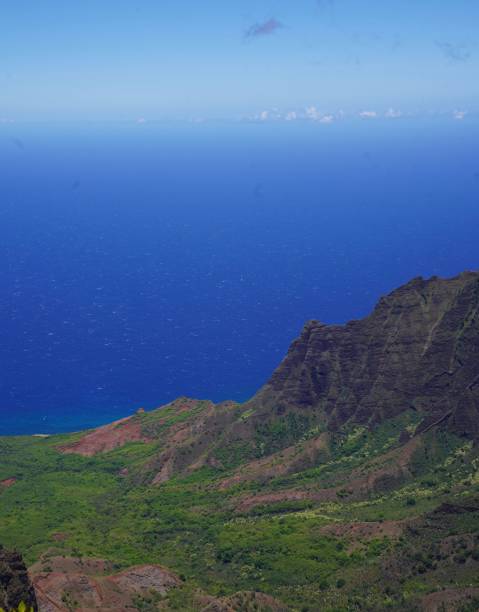 istock a man is standing on a mountain overlooking the ocean and mountains 1751716292