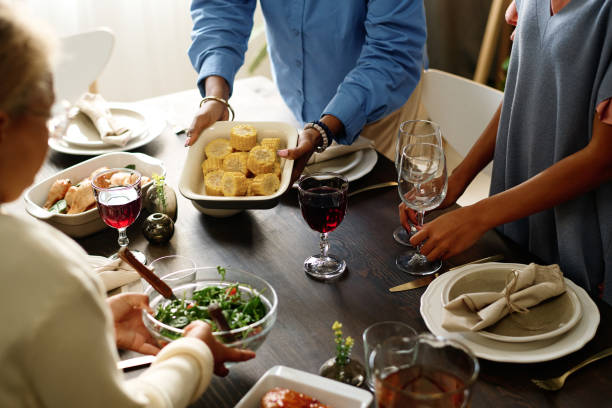 istock Two girls helping their mother serve festive table while putting wineglasses 1751717392