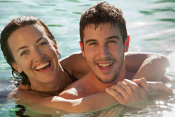 istock Couple swimming laughing - horizontal 175171779