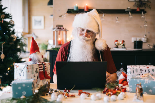 istock Santa claus working with laptop at home 1751719136