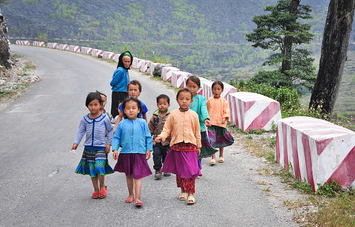 Ha Giang, Vietnam - Oct 14, 2014. Group of Hmong people on mountain road in Ha Giang province, Vietnam. Ha Giang shares a 270 km long border with Yunnan province of southern China.