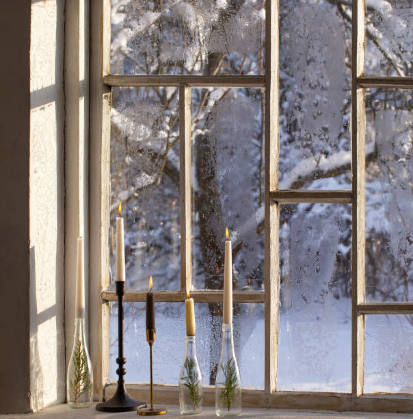 istock old window with winter landscape and burning candles on windowsill 1751724755