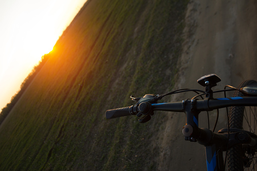 Bycycle in the field. Sunset