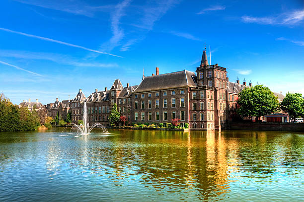 Dutch Parliament, The Hague, Netherlands "Binnenhof (Dutch Parliament), The Hague (Den Haag), The Netherlands. Visible are Historic buildings, art museum Mauritshuis along the pond Hofvijver, fountain and beautiful cloudscape over the reflection in the water." the hague photos stock pictures, royalty-free photos & images