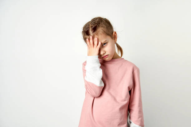 istock Cute child girl tired having headache, white background 1751727888