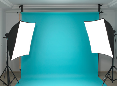 Empty photographic studio ready for shoot with blue background