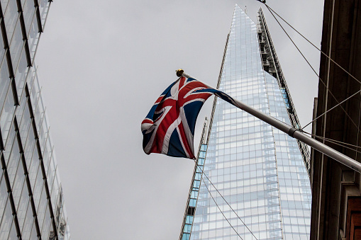 Typical London view: grey clouds before the rain, the Union Jack, and the Shard seen from below