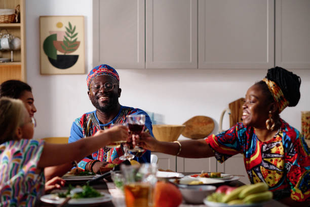 istock Happy young African American family clinking with drinks over served table 1751740149