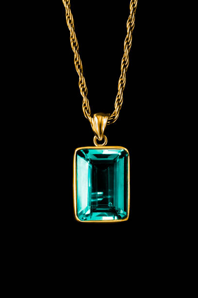 Large topaz golden necklace hanging on black background