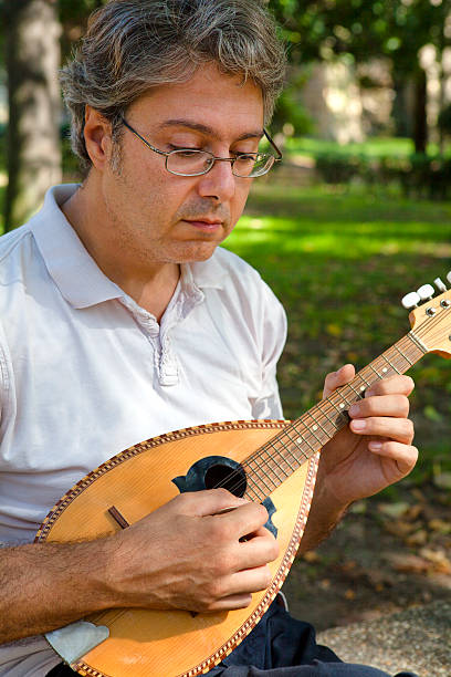 istock Man Playing Mandolin Outdoors 175174714