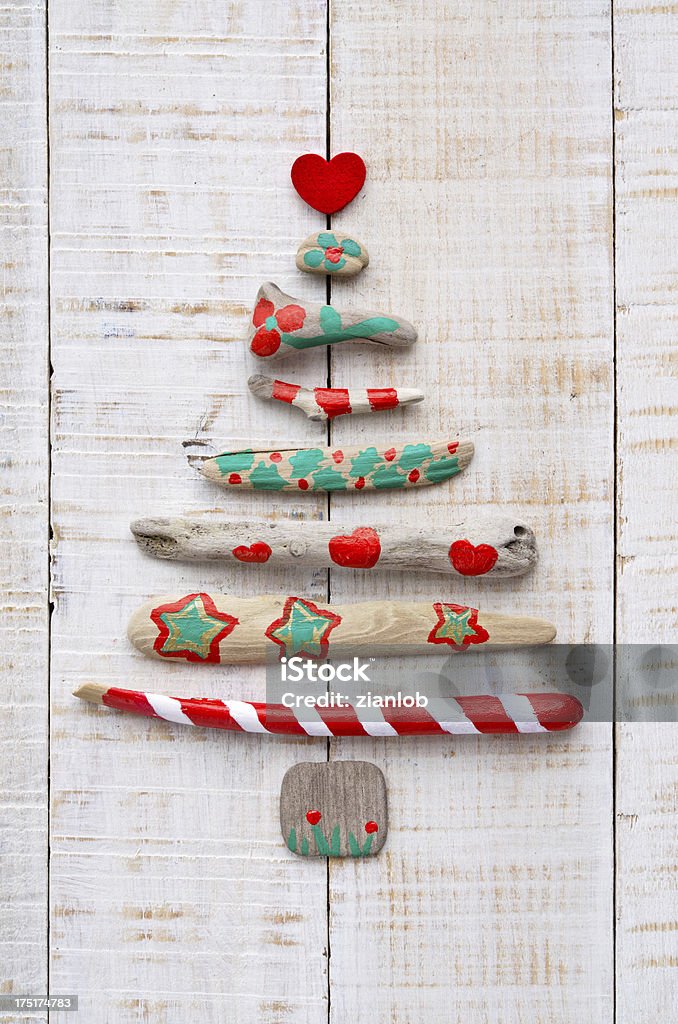 Painted driftwood Christmas tree on textured wood Christmas tree made of wood from the sea. Christmas Stock Photo