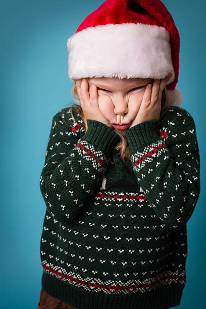istock Santa's Stressed/Frustrated Little Helper Wearing Hat and Christmas Sweater 175175075