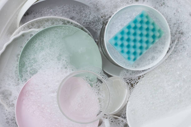 istock Dishes and bowls in water and bubbles of dishwashing liquid. Kitchen work 1751756113