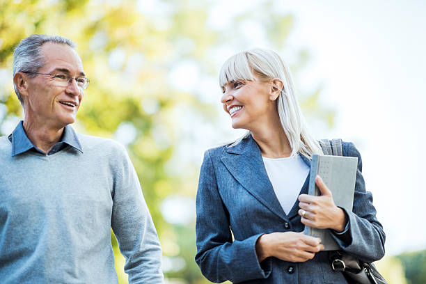 Two businesspeople taking a walk in park.