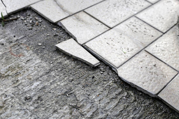 istock Cracked brown tiles on cement floor 1751758998