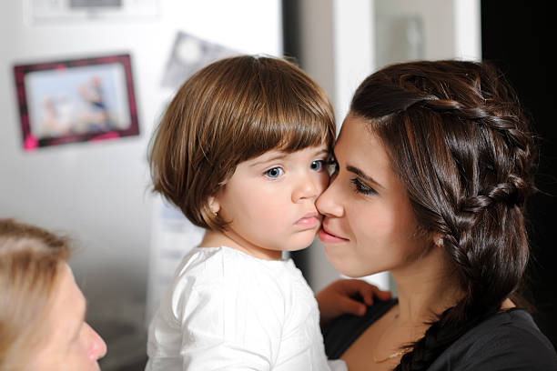 mother with girl beautiful mother embracing her little girl.indoors shoot. grandmother real people front view head and shoulders stock pictures, royalty-free photos & images