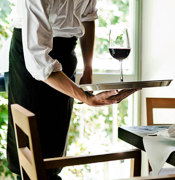 istock Waiter serving a glass of wine 175176432