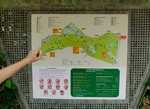 Singapore - Dec 14, 2015. A hand on the map of city park in Singapore. Singapore, referred to as the Lion City, the Garden City, is a sovereign city-state in Southeast Asia.