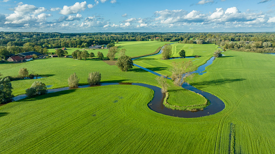 aerial view of a beautiful green landscape with a small river flowing through. It is in the eastern part of the Netherlands