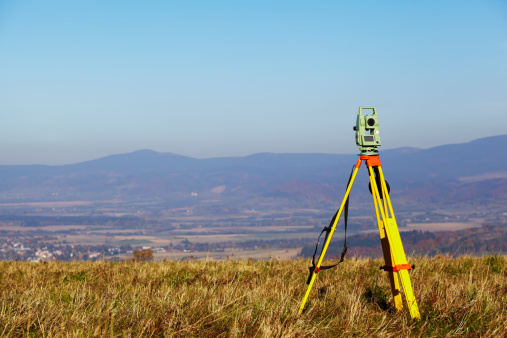 Total station - land surveying equipment - mount on tripod ready to measure.
