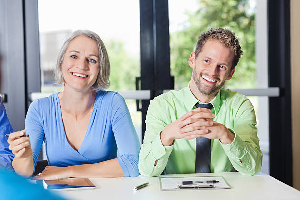 istock Professional coworkers interviewing prospective employee at conference event 175177587