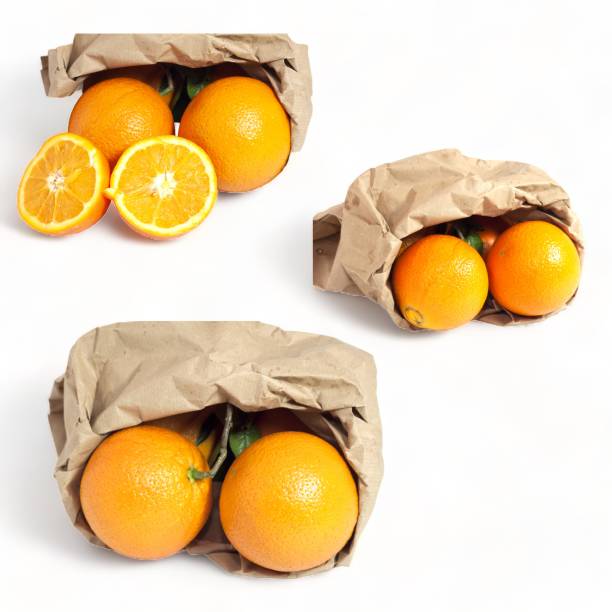 istock Orange fruit with paper bag on white background- 1751776226