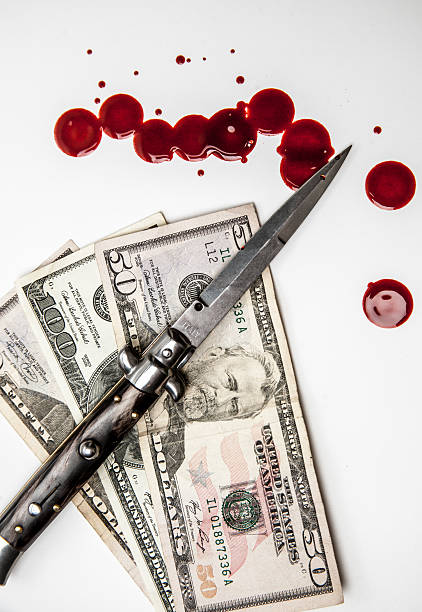 Crime in America Switchblade knife US money and blood splatters "an isolated image of a stiletto italian switchblade knife laying over 2 - 50 dollar bills and a one hundred dollar bill. There are blood splatters. Shows crime, theft and murder as a concept. Isolated on white" bloody money stock pictures, royalty-free photos & images