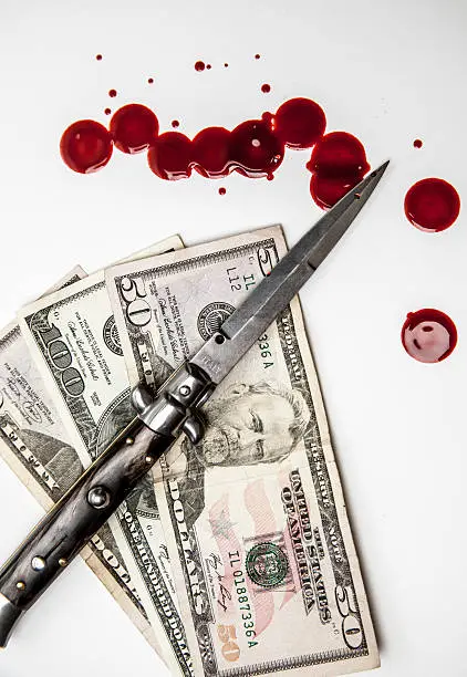 Photo of Crime in America Switchblade knife US money and blood splatters