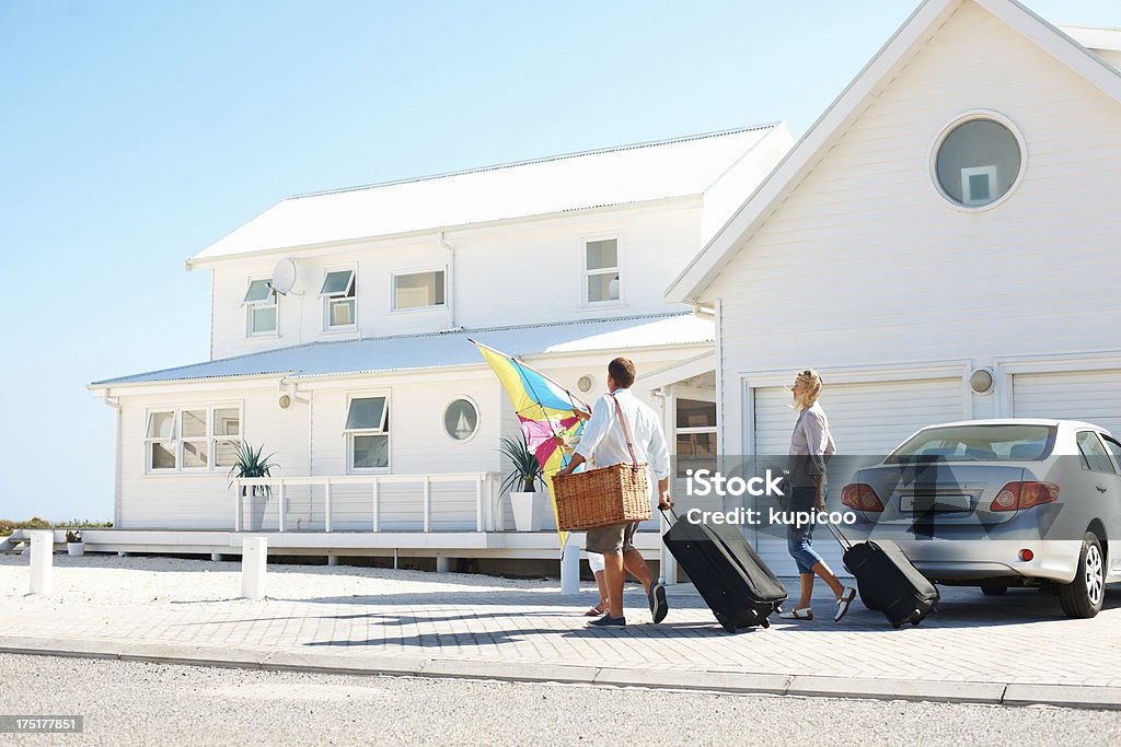 Arriving at their holiday destination Young family arriving at their holiday beach house Vacation Rental Stock Photo
