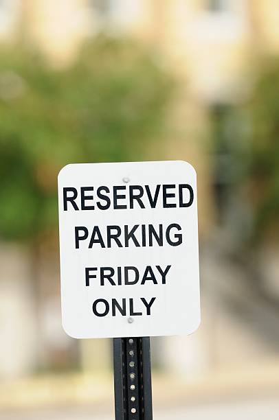 istock Reserved parking Friday only sign close up 175178082