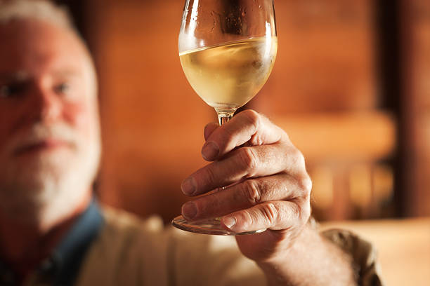 istock Winemaker Taster Tasting a Glass of White Wine Hz 175178250