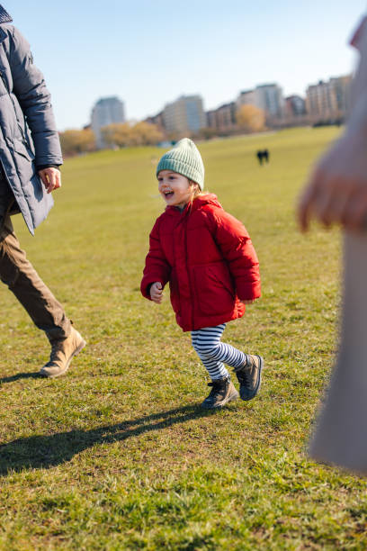 istock A Happy Beautiful Girl Looking Away While Enjoying Spending Time With Her Unrecognizable Parents 1751782680