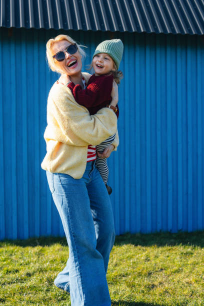 istock A Happy Beautiful Single Mother With Sunglasses Laughing While Playing With Her Cute Little Child (Looking Away) 1751783017