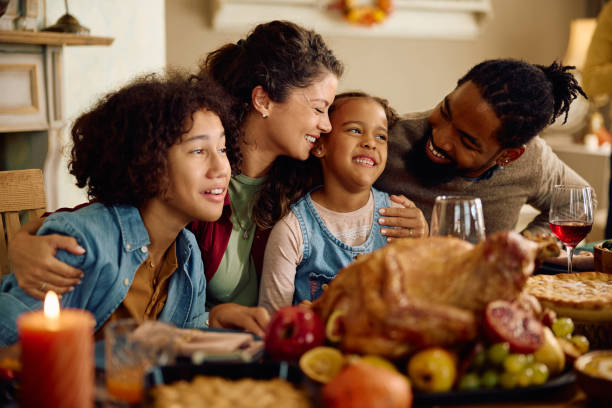 istock Happy multiracial family enjoying on Thanksgiving at dining table. 1751783040