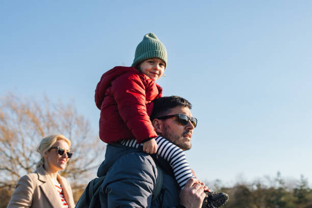 istock A Happy Beautiful Child Looking At Camera While Sitting On Her Father's Shoulders 1751783053