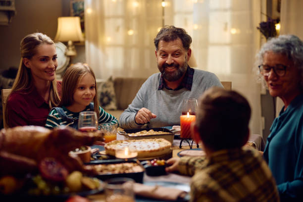 istock Happy multigeneration family talking while eating at dining table on Thanksgiving. 1751789312