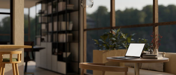 istock A white-screen laptop mockup with accessories on a table in a modern and comfortable cafe or lounge. 1751791734