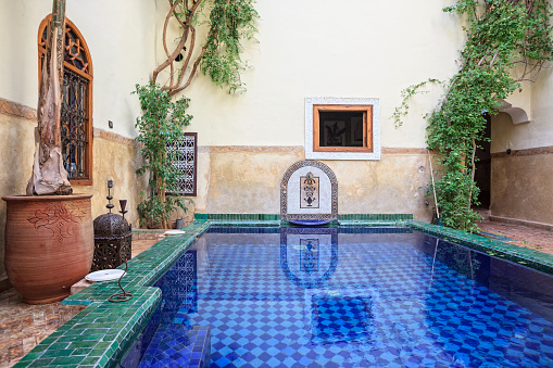 Courtyard of a riad with swimming pool in Marrakech, Morocco. The so called Riads (from the arabic word Ryad which means garden) are traditional houses with a courtyard or garden in the middle.