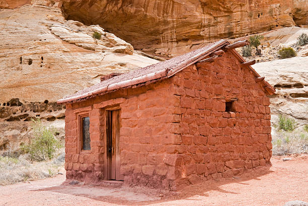 Historic Behunin Cabin Elijah Cutler Behunin was a Mormon pioneer. He and his family lived in a one room sandstone cabin between 1883-84. The Behunins lived there for only a year, leaving for Fruita, Utah after a flood threatened the house and its fields. The cabin is preserved in what is now Capitol Reef National Park, Utah, USA. jeff goulden capitol reef national park stock pictures, royalty-free photos & images