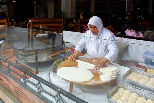 Istanbul, Turkey, 9th of October 2023, A turkish woman preparing gozleme,(Turkish, gözlemeler) that is a traditional turkish bread.
