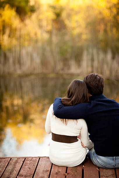 istock Serene Couple Sitting Together Outside on Deck Overlooking Pond 175179795