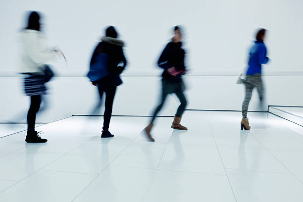 istock Silhouettes of People Walking on White Interior Blurred Motion 175179936
