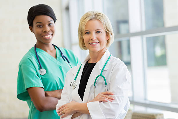 istock Smiling doctor and her assistant looking at camera 175180066