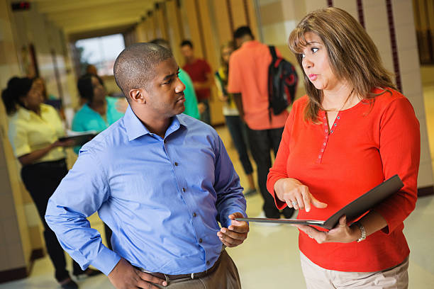 istock High school teachers disagreeing about something after class 175180253