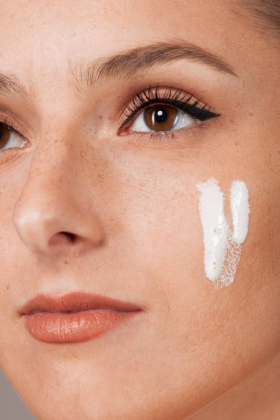 istock Delighted female with radiant skin applying cream 1751803039