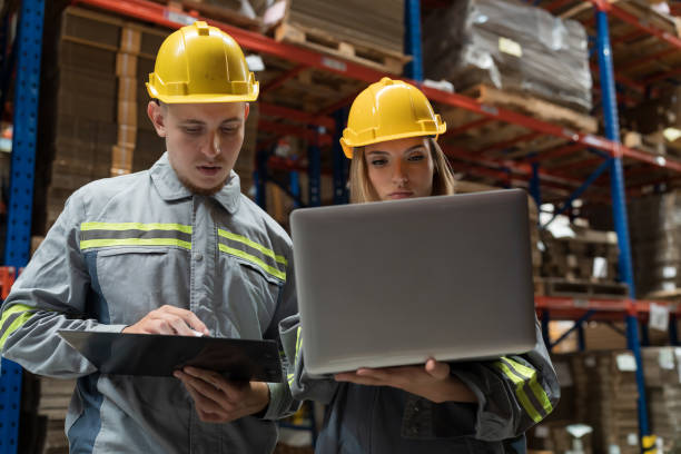 istock Male and female warehouse worker working and discussing in warehouse storage. Warehouse workers inspecting quality of barcodes on shelves pallet 1751806659