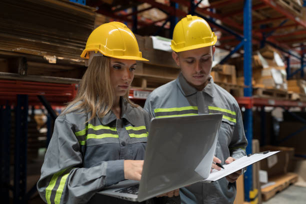 istock Male and female warehouse worker working and discussing in warehouse storage. Warehouse workers inspecting quality of barcodes on shelves pallet 1751806667
