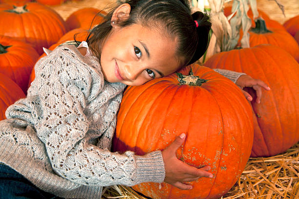 istock Little Girl with a Halloween Pumpkin 175180689